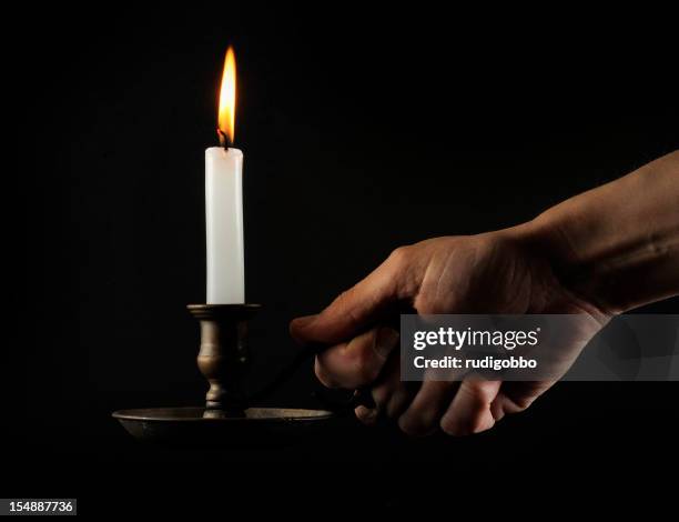 hand holding a lit candle in the dark - blackout stock pictures, royalty-free photos & images