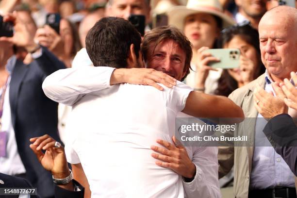 Carlos Alcaraz of Spain celebrates victory with his coach, Juan Carlos Ferrero following the Men's Singles Final against Novak Djokovic of Serbia on...