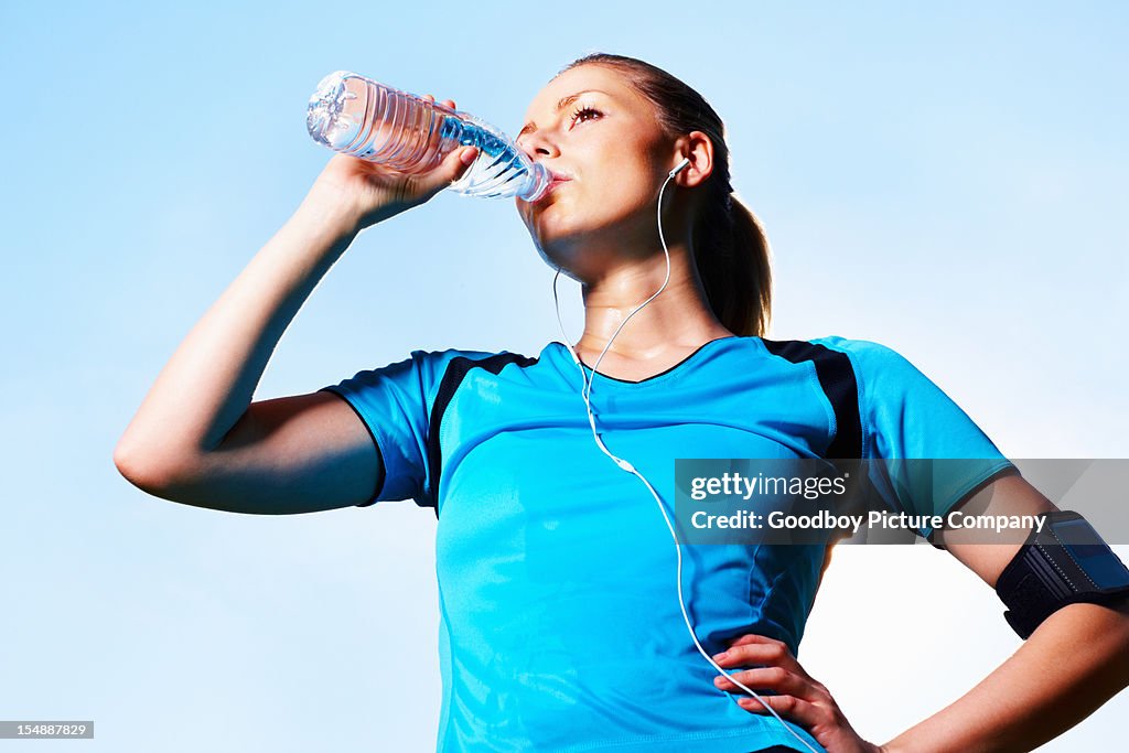 Woman drinking cool water after a long run