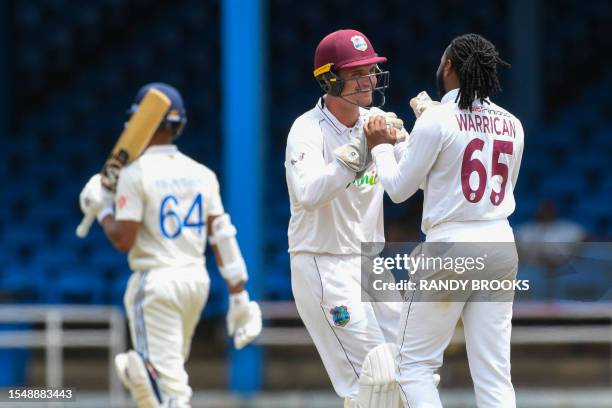 Joshua Da Silva and Jomel Warrican , of West Indies, celebrate the dismissal of Yashasvi Jaiswal , of India, during the fourth day of the second Test...