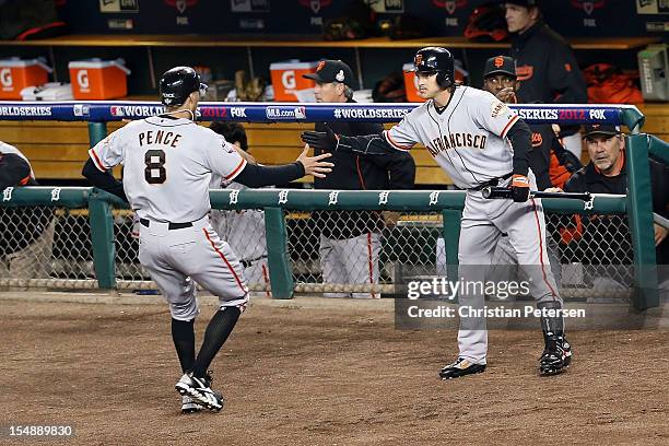 Hunter Pence of the San Francisco Giants celebrates with his teammate Ryan Theriot going to the dugout after scoring a run off of Brandon Belt RBI...