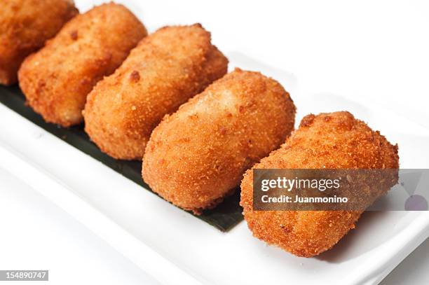 cod fish croquettes on white background - kroket stockfoto's en -beelden