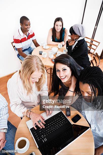 vista dall'alto di giovani felice condivisione di computer portatile in sala ristoro - circondare foto e immagini stock