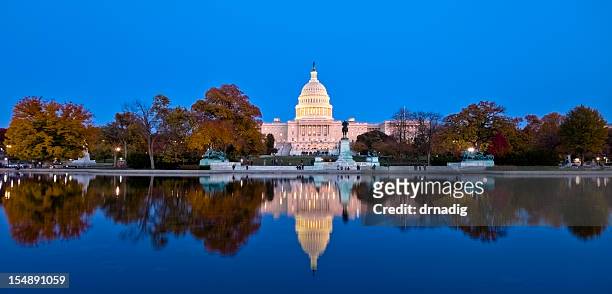 a beautiful reflection of united states capitol at dawn - washington dc stockfoto's en -beelden