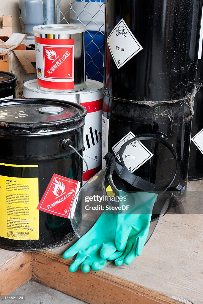 Five piled buckets containing flammable liquids