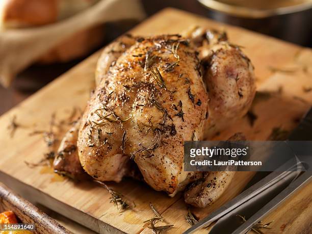 roasted chicken with fresh thyme - roasted chicken stock pictures, royalty-free photos & images