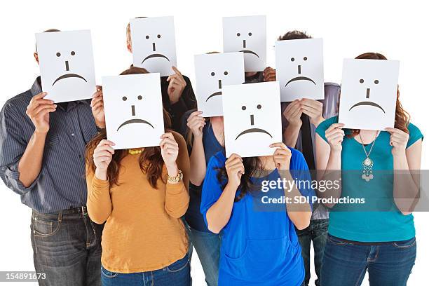 group of people holding sad face signs up - relatieproblemen stockfoto's en -beelden