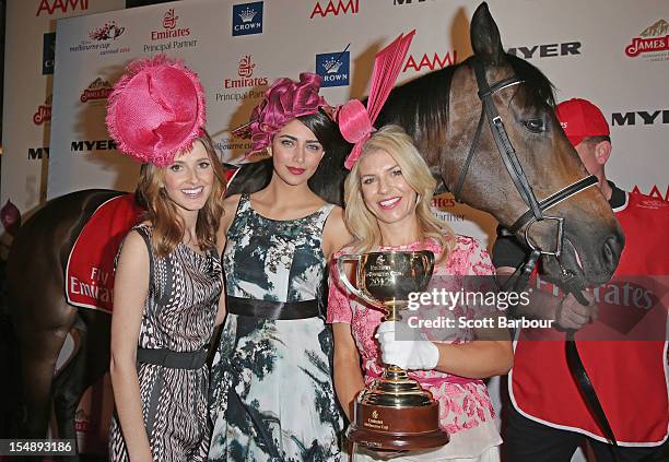 Kate Waterhouse, Samantha Downie and Alison Saville pose with the Melbourne Cup during the The 2012 Melbourne Cup Carnival Launch at Crown Palladium...