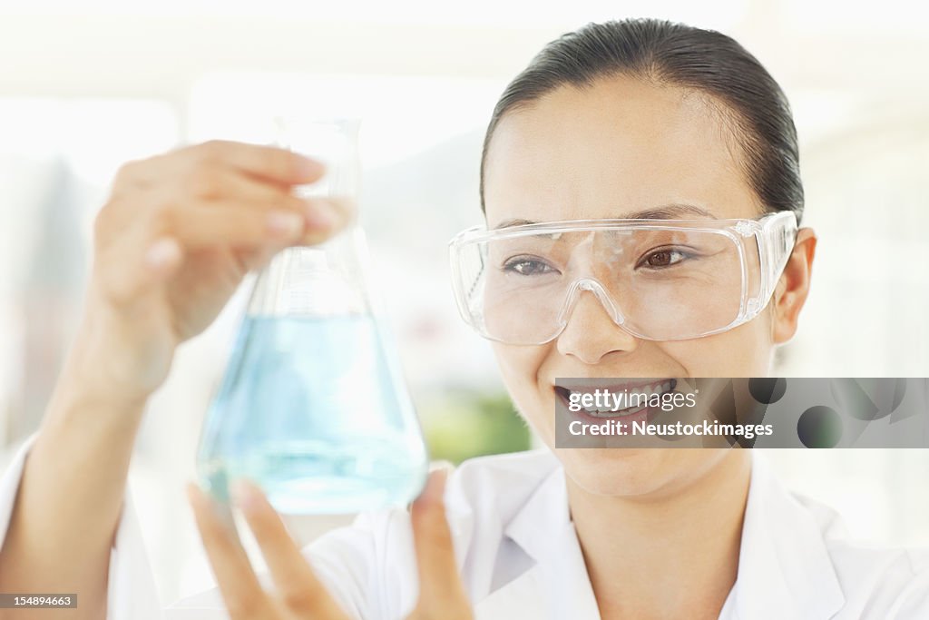 Scientist Examining a Flask