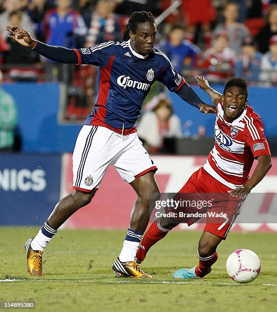 Shalrie Joseph of Chivas USA and Fabian Castillo of FC Dallas battle for possession during the second half of a soccer game at Pizza Hut Park on...