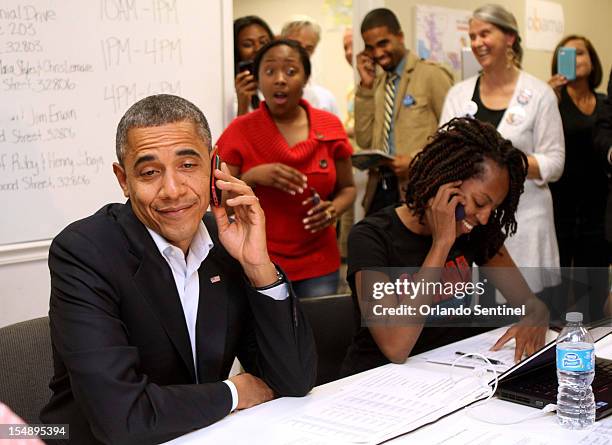 President Barack Obama makes a funny face after he is connected to a wrong number while calling to thank campaign volunteers at the "Obama For...