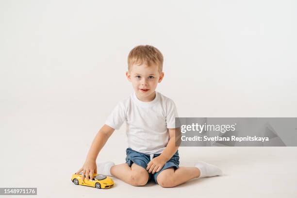 toddler boy playing with a car - boy playing with cars stock pictures, royalty-free photos & images