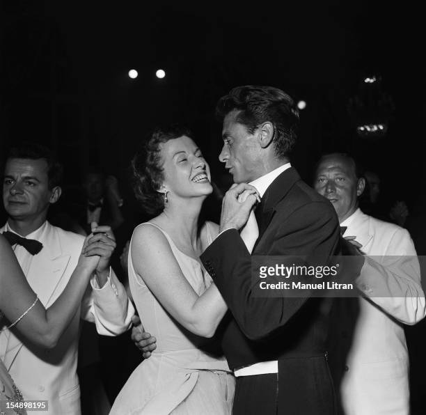 Serge Reggiani, Robert LAMOUREUX dancing with Betsy Blair at the ball of the little white beds in Deauville Casino.