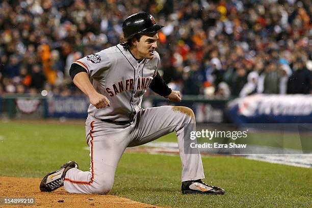 Ryan Theriot of the San Francisco Giants celebrates after scoring a run off of Marco Scutaro RBI single against Phil Coke of the Detroit Tigers in...