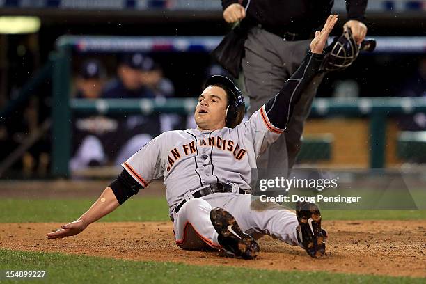 Ryan Theriot of the San Francisco Giants slides to home after a run off of Marco Scutaro of the San Francisco Giants an RBI single to center field...