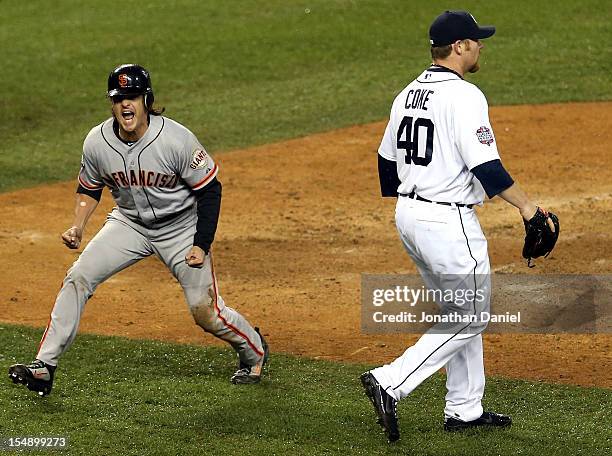 Ryan Theriot of the San Francisco Giants celebrates after scoring a run off of Marco Scutaro's RBI single against Phil Coke of the Detroit Tigers in...