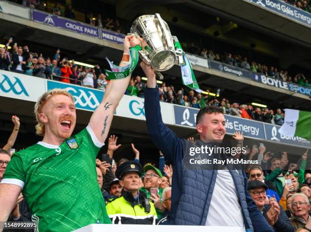 Dublin , Ireland - 23 July 2023; Limerick players Cian Lynch, left, and Declan Hannon lift the Liam MacCarthy Cup after their side's victory in the...