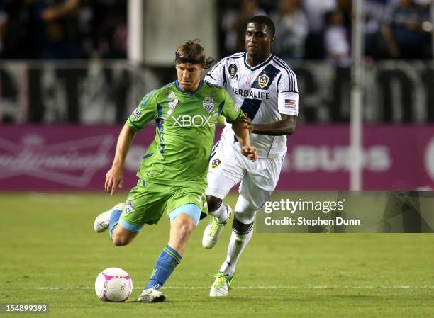 Jeff Parke of the Seattle Sounders controls the ball in front of Edson Buddle of the Los Angeles Galaxy at The Home Depot Center on October 28, 2012...