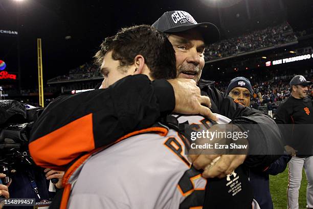 Manager Bruce Bochy of the San Francisco Giants hugs Buster Posey after defeating the Detroit Tigers to win Game Four of the Major League Baseball...