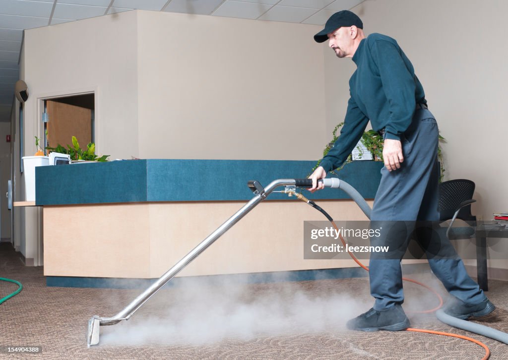 Professional Carpet Cleaner - Man Steam Cleaning