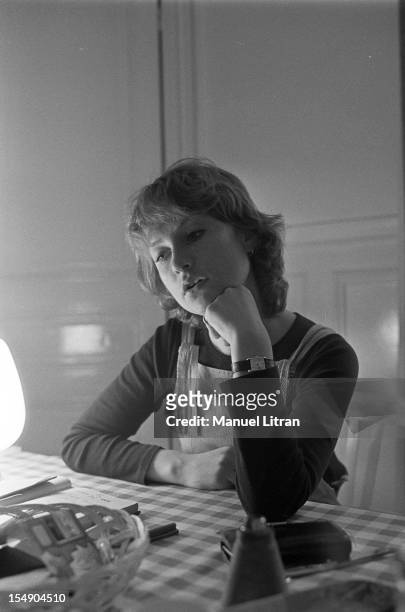 May 20 the actress Isabelle Huppert in his apartment during the film 'The Lacemaker' by Claude Goretta, Portrait of Isabelle Huppert, sitting at a...