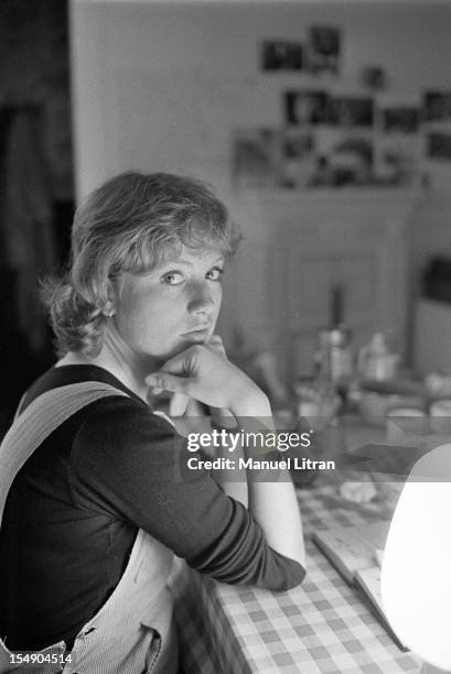 May 20 the actress Isabelle Huppert in his apartment during the film 'The Lacemaker' by Claude Goretta, Isabelle Huppert, sitting at a table.