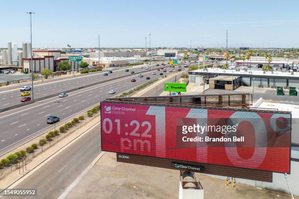 In an aerial view, a billboard displays the temperature that was forecast to reach 115 degrees Fahrenheit on July 16, 2023 in Phoenix, Arizona. A...