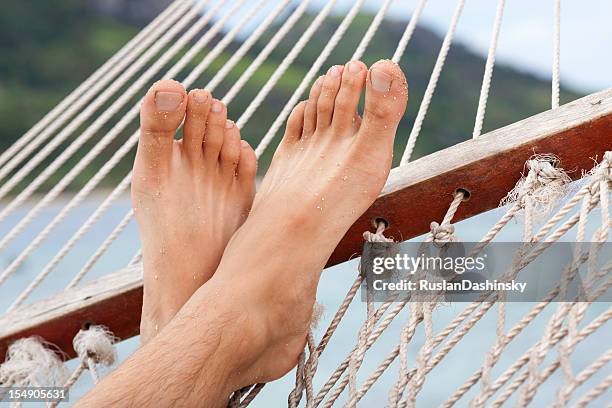 feet in hammock. - crossed legs heels stock pictures, royalty-free photos & images