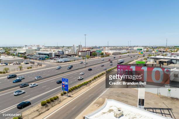 In an aerial view, a billboard displays the temperature that was forecast to reach 115 degrees Fahrenheit on July 16, 2023 in Phoenix, Arizona. A...