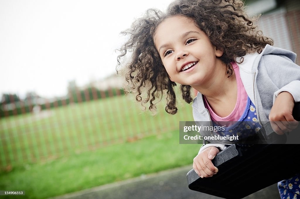 Happy 4 years old Girl on the Swing