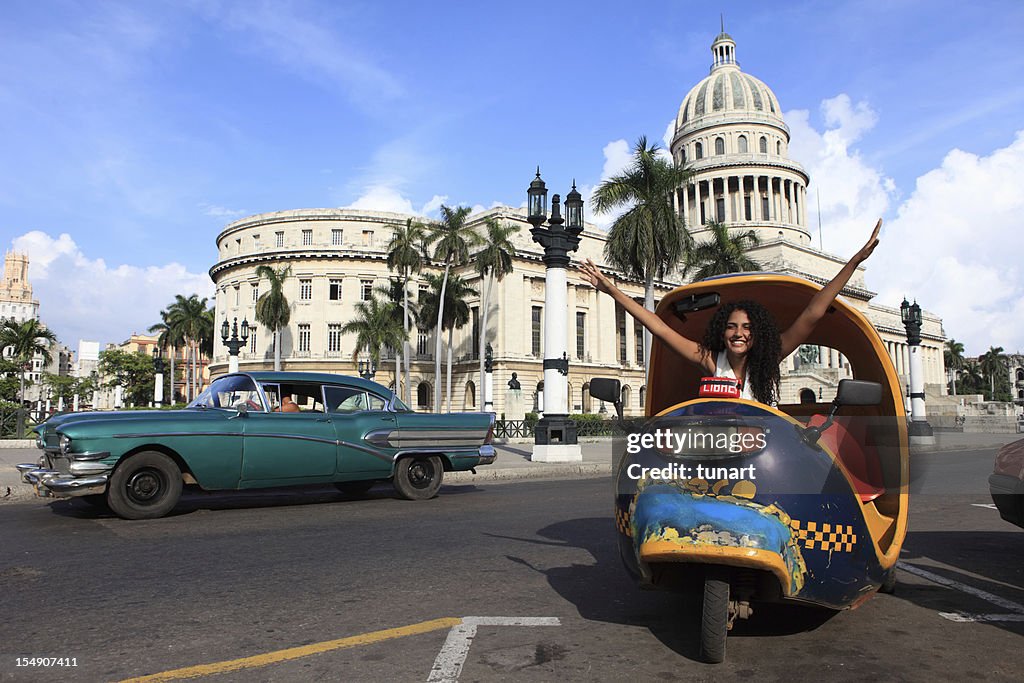 Cuban Girl in Coco Taxi infront of Capitolio, Havana, Cuba