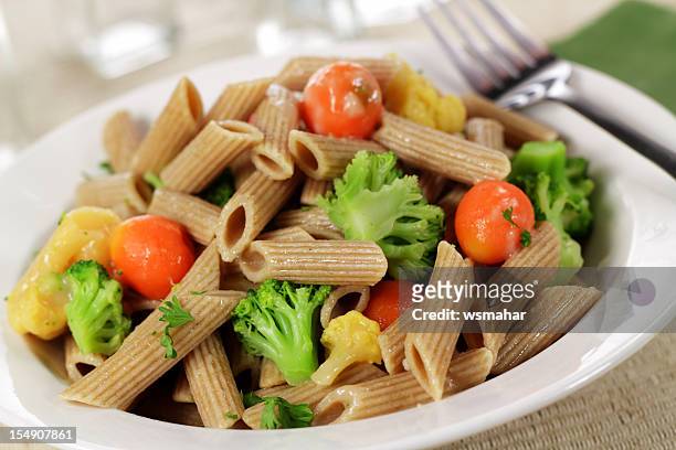 lunch consisting of whole wheat pasta and vegetables - wholegrain stock pictures, royalty-free photos & images