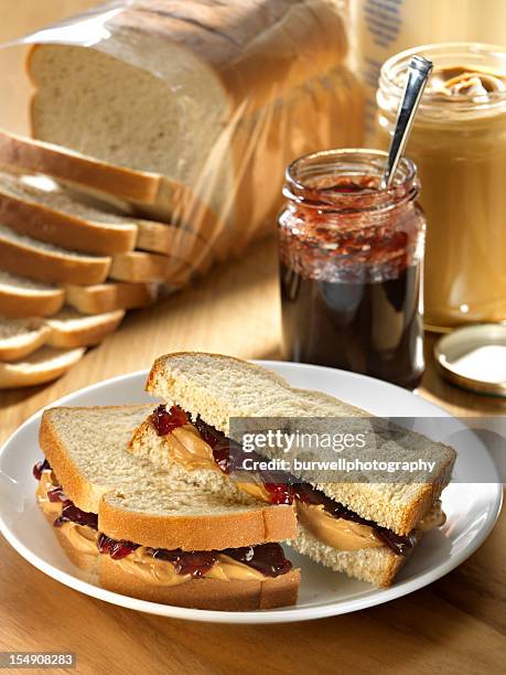 a photograph of a peanut butter and jelly sandwich - peanut butter and jelly sandwich stock pictures, royalty-free photos & images