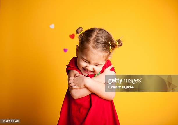 great big valentine hug, cute girl hugging herself - valentines day children stock pictures, royalty-free photos & images