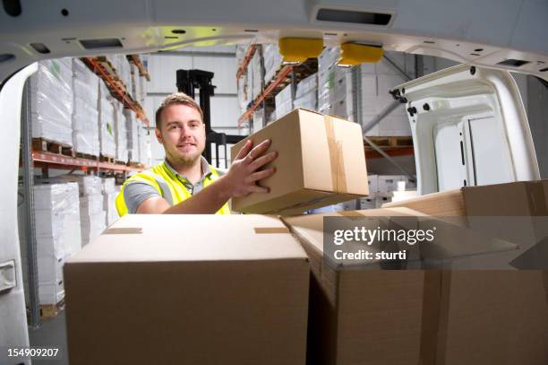 warehouse worker loading a delivery van - delivery van stock pictures, royalty-free photos & images