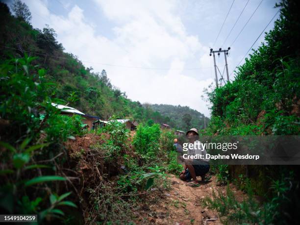 Civilian seeks shelter as fighter jets circle overhead, which later bomb the nearby mountain on May 26, 2023 in Kayah State, Myanmar. Since the...