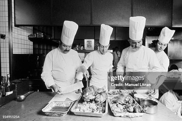 June 1976, the great chefs of French cuisine: the brothers Jean and Pierre Troisgros in the kitchen of their restaurant Three Stars has Roanne, They...