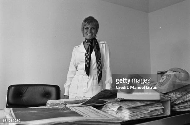 August 1969, Annie FARGUE, producer of the musical 'Hair' in his office in Paris, wearing a scarf around his neck.