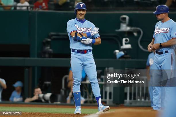 Nathaniel Lowe of the Texas Rangers reacts after driving in a run against the Cleveland Guardians in the third inning at Globe Life Field on July 16,...