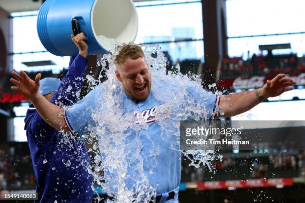 Will Smith has water poured on him by Martin Perez of the Texas Rangers after the game against the Cleveland Guardians at Globe Life Field on July...