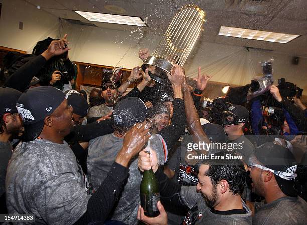 The San Francisco Giants celebrates the Commissioner's Trophy in the locker room after defeating the Detroit Tigers to win Game Four of the Major...