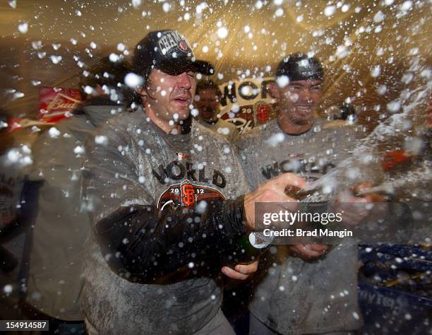 Barry Zito and Eli Whiteside of the San Francisco Giants celebrate in the clubhouse after defeating the Detroit Tigers to win the 2012 World Series...