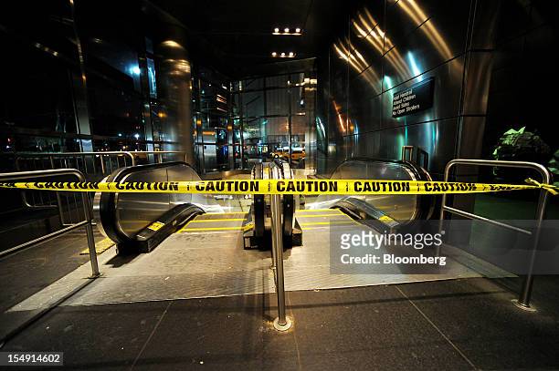Caution tape cordons off a subway entrance at Columbus Circle due to closure in New York, U.S., on Sunday, Oct. 28, 2012. The U.S. Securities...