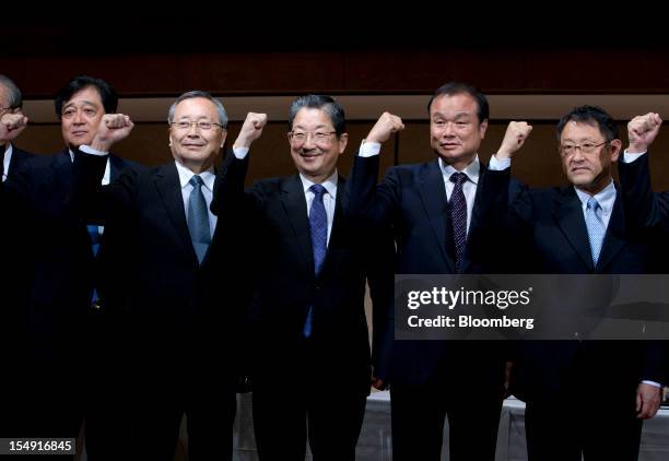 Osamu Masuko, president of Mitsubishi Motors Corp., from left, Takashi Yamanouchi, chief executive officer of Mazda Motor Corp., Toshiyuki Shiga,...