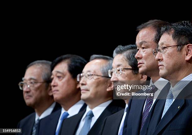 Osamu Masuko, president of Mitsubishi Motors Corp., from second left, Takashi Yamanouchi, chief executive officer of Mazda Motor Corp., Toshiyuki...