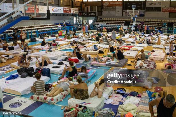 People evacuated from their home take shelter at a sports hall in Venetokleio due to wildfires on Rhodes island, Greece on July 23, 2023. Some 19,000...