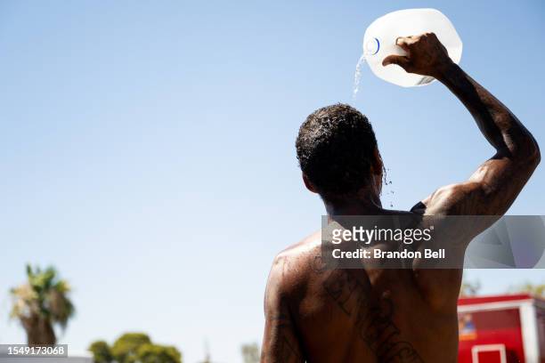 Person cools off amid searing heat that was forecast to reach 115 degrees Fahrenheit on July 16, 2023 in Phoenix, Arizona. A heat dome over Texas...