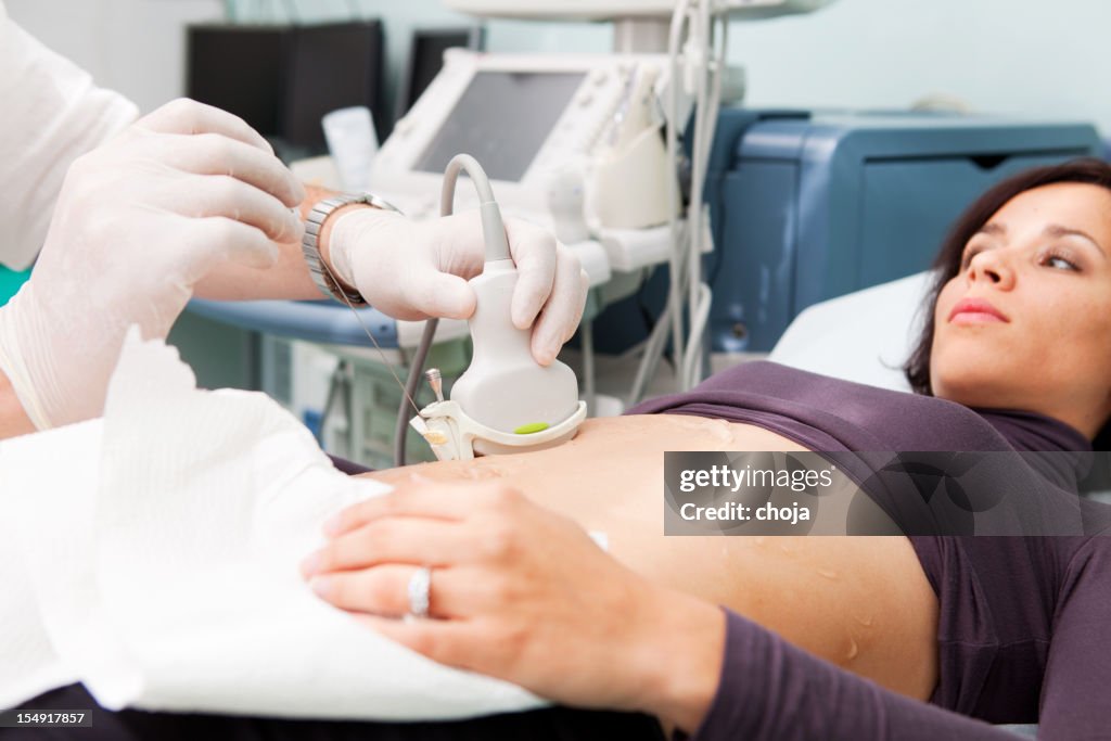 Doctor making liver biopsy to a young women..supporting with Ultrasound
