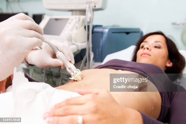 doctor making liver biopsy to a young women..supporting with ultrasound - biopsy stock pictures, royalty-free photos & images