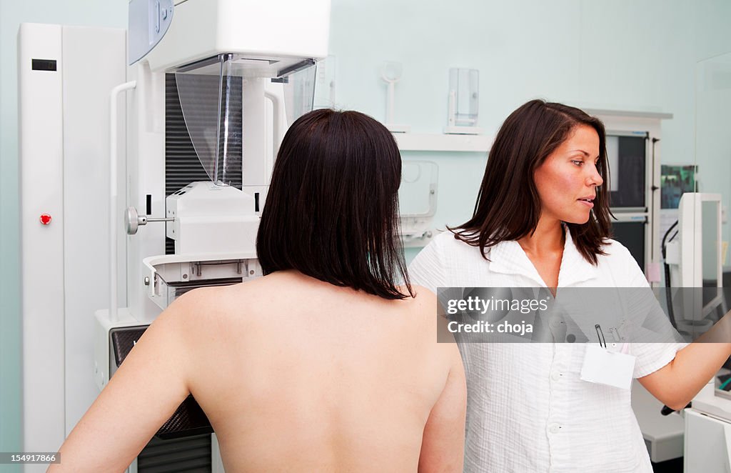 Nurse with young women having a mammogram